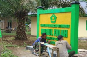 Jelang Penutupan, Personel Satgas TMMD Ke-123 Kodim 0416/Bute Kebut Pengecatan Papan Nama MI Nurul Falah
